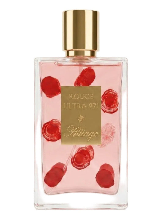 A clear rectangular perfume bottle filled with pale pink liquid, decorated with red rose illustrations, featuring a gold cap and a gold front label that reads 'ROUGE ULTRA 97' and 'Alliage'.